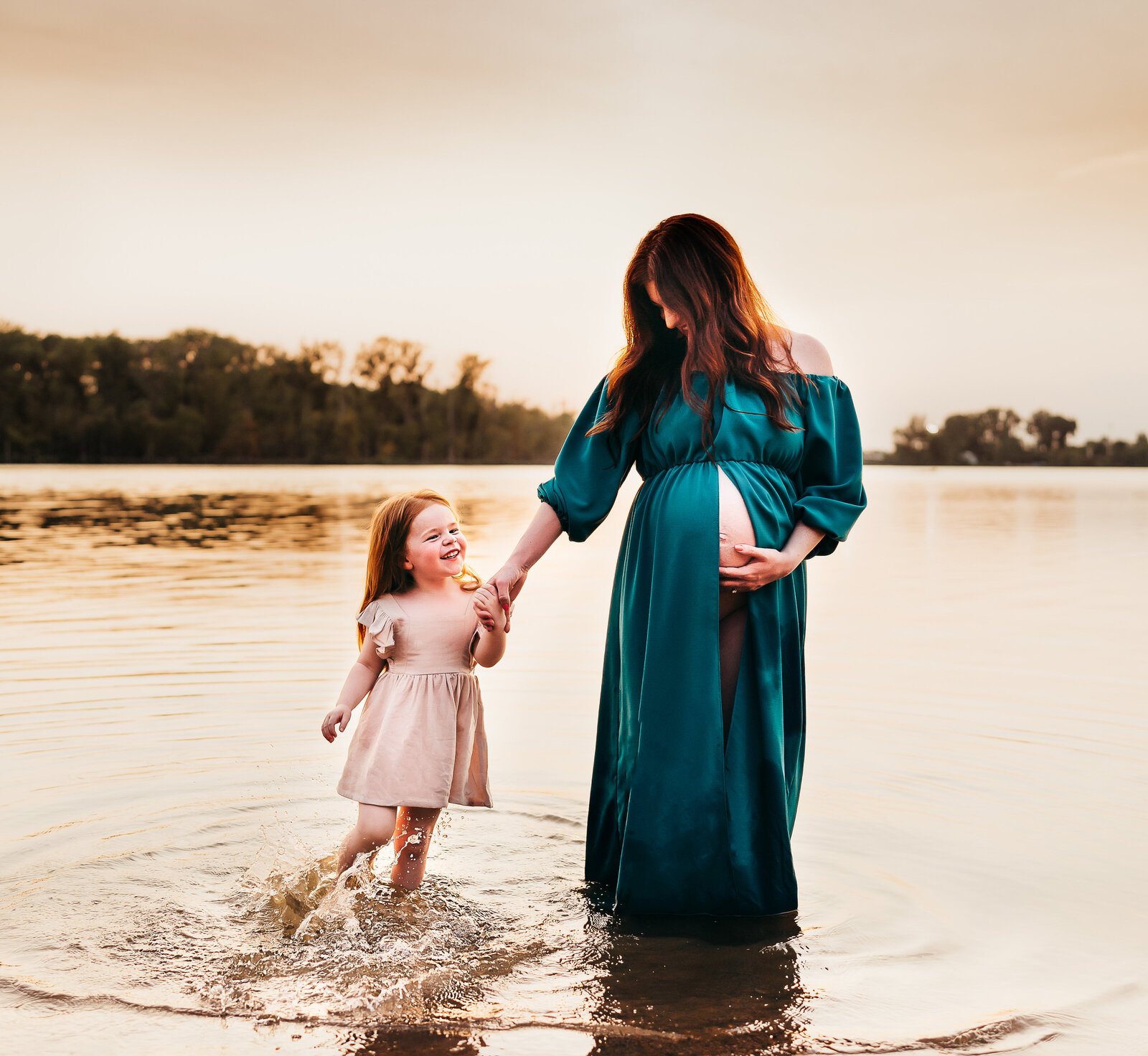 mom holding daughter's hand in water