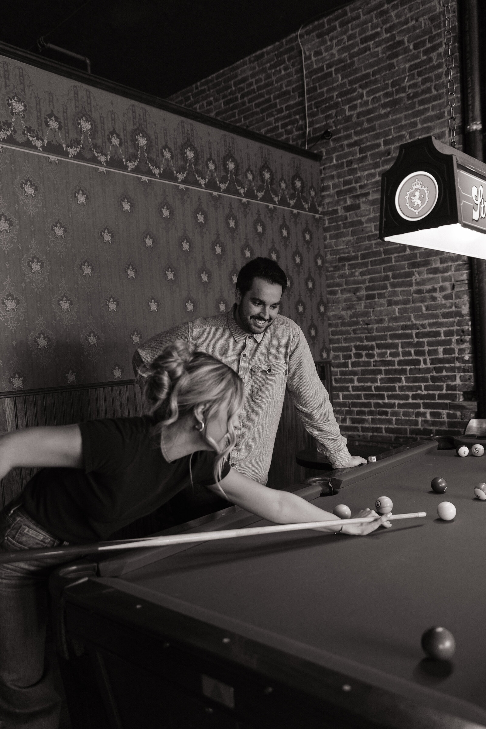 Playful engagement portraits in vintage Idaho saloon setting
