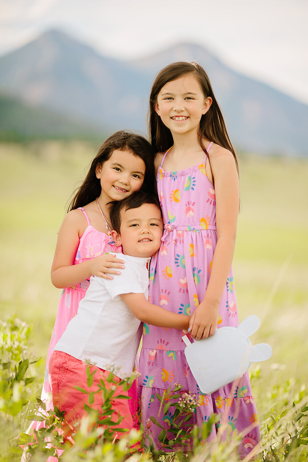 Family Photography, three siblings standing and holding each other