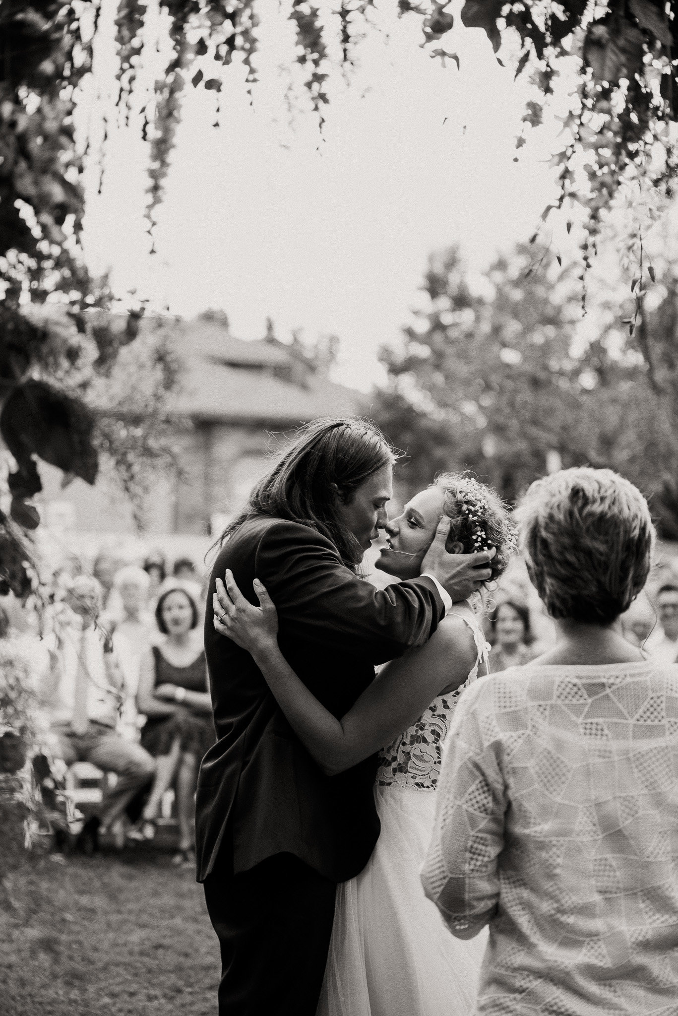 first kiss in black and white at a wedding in Casper Wyoming.
