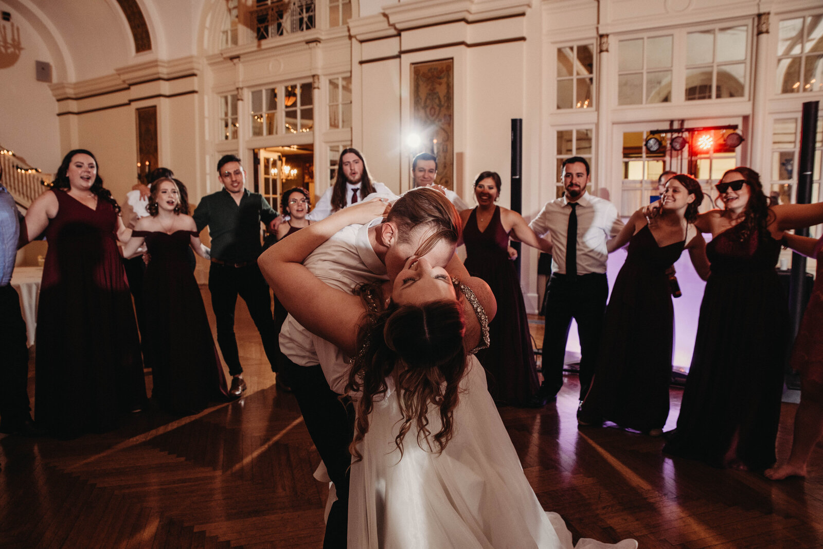 Couple dip and kiss at reception in Greystone Hall Akron.