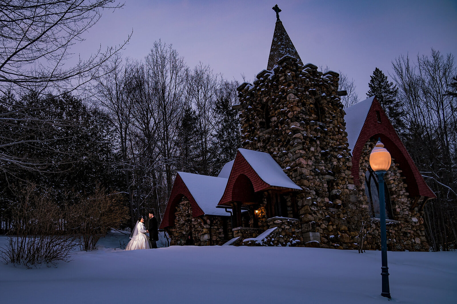 Wedding couple in front of Baker Memorial Chapel in Saranac Lake NY