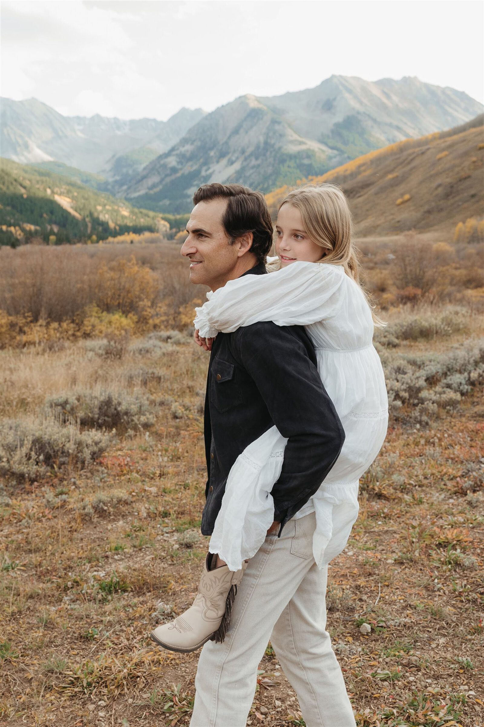 Aspen family photography with a Ralph Lauren aesthetic — navy, camel, and cream tones against alpine greens in the Roaring Fork Valley.