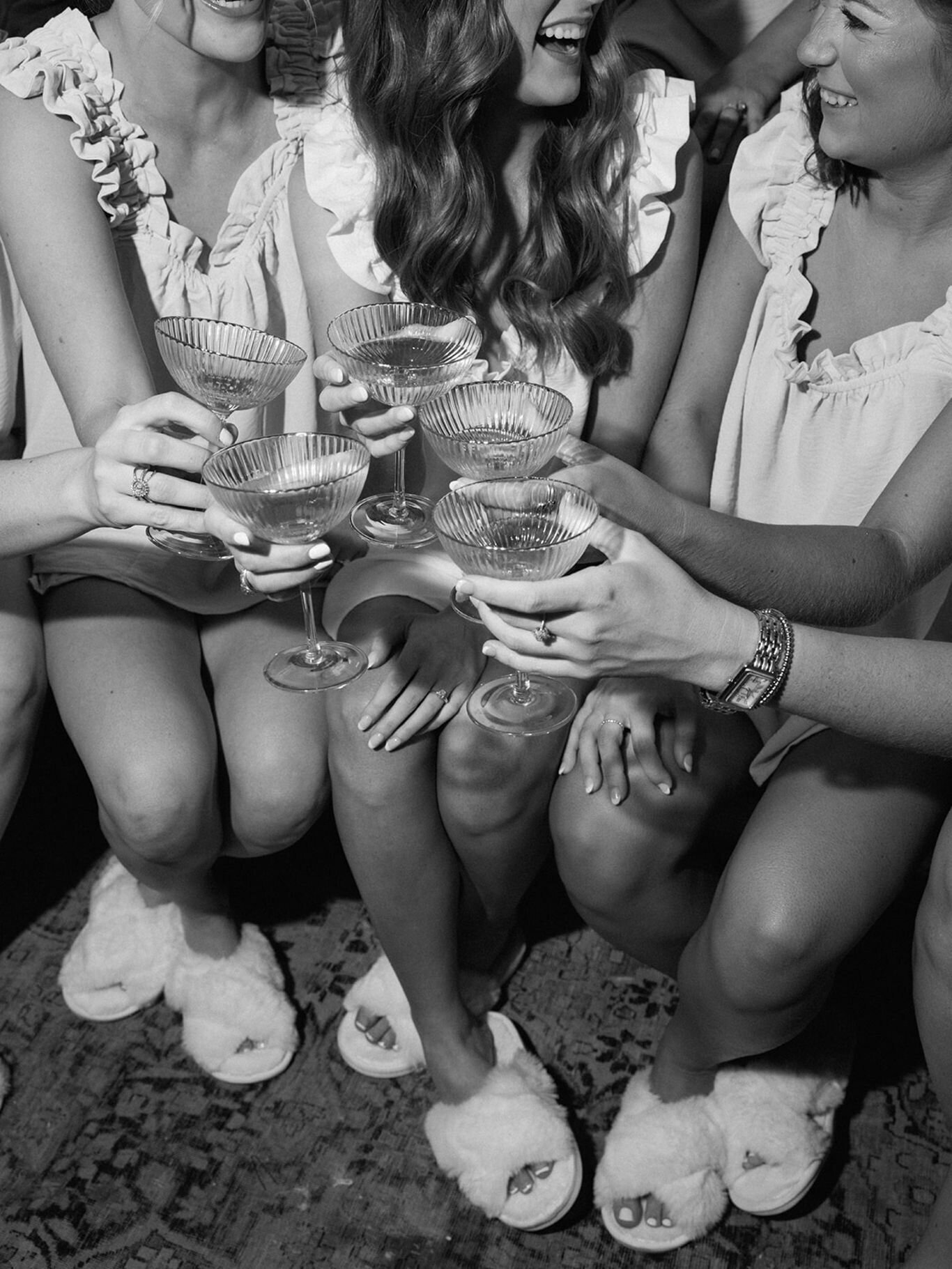 Bridesmaids raising champagne glasses during the wedding morning celebration.
