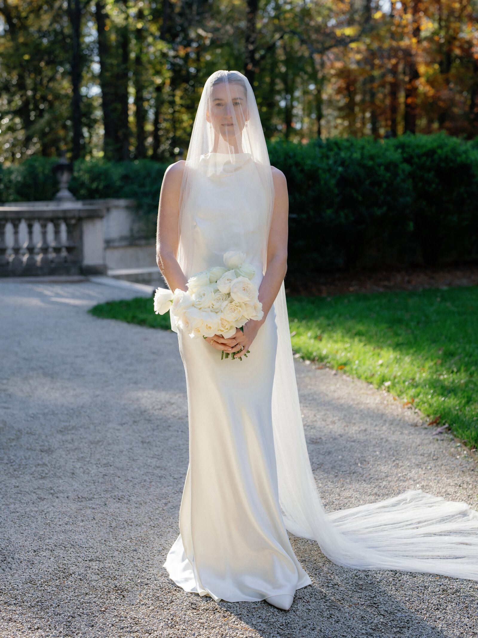 Bridal portrait with veil draped over face, creating a soft, ethereal look.