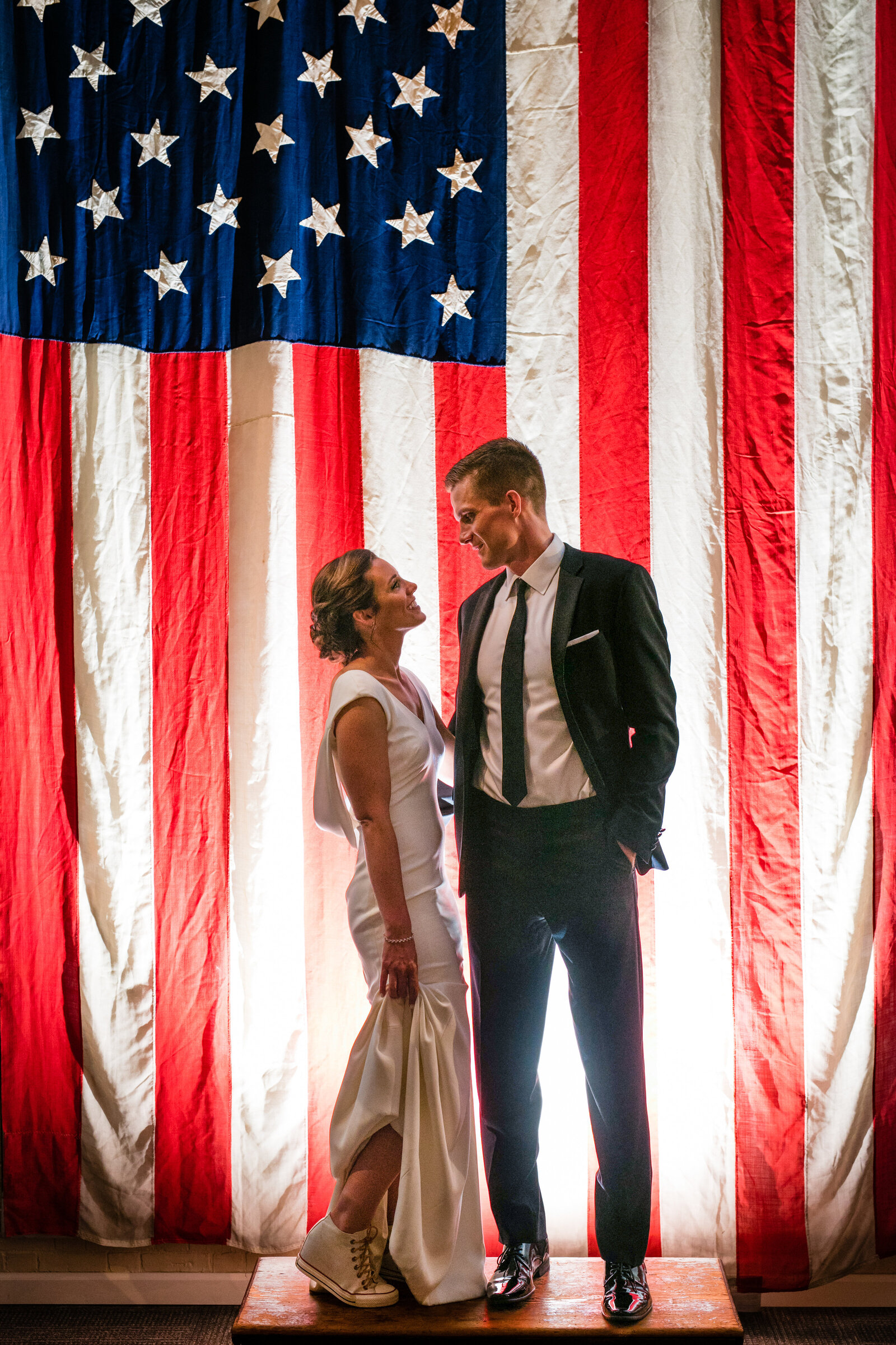 couple poses in front of american flag exhibit at whaling museum