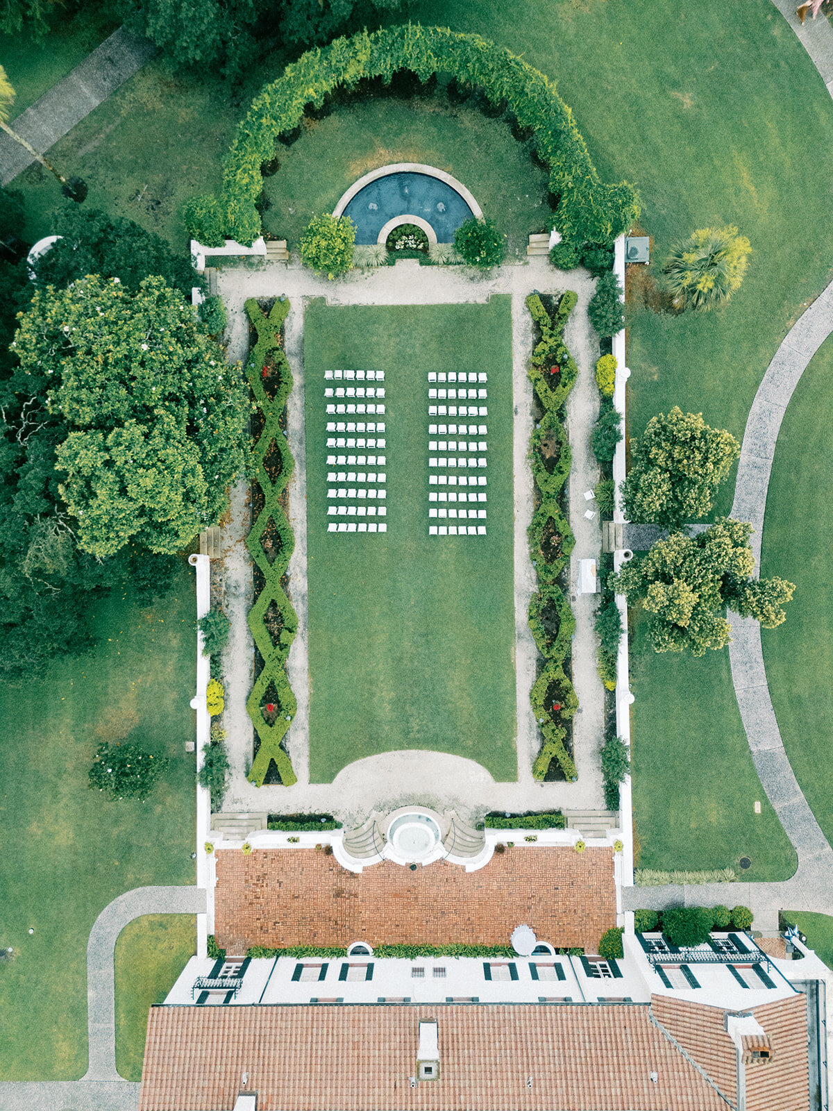 Aerial drone view of wedding chairs in Crane Cottage's courtyard wedding at Jekyll Island Club Resort