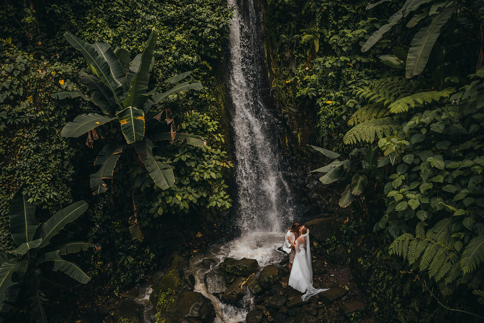 married couple by waterfall