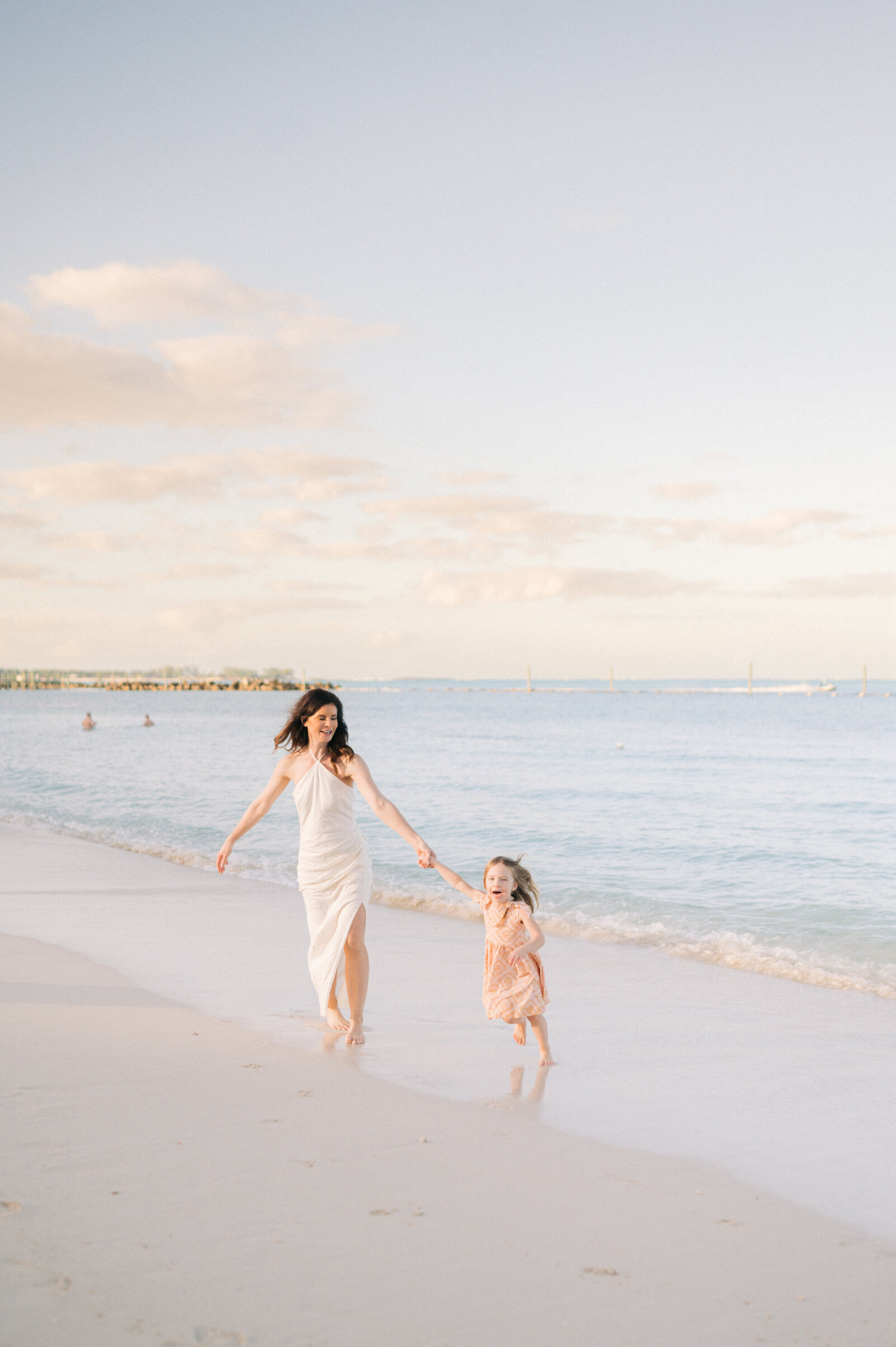 Family with small children holding hands on the beach at Grand Hyatt Baha Mar