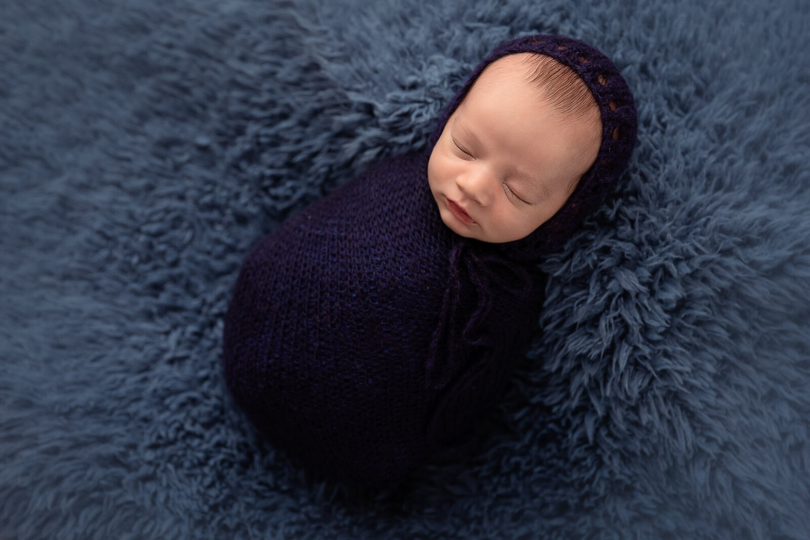 baby in navy swaddle and hat by Newborn Photography Bucks County PA