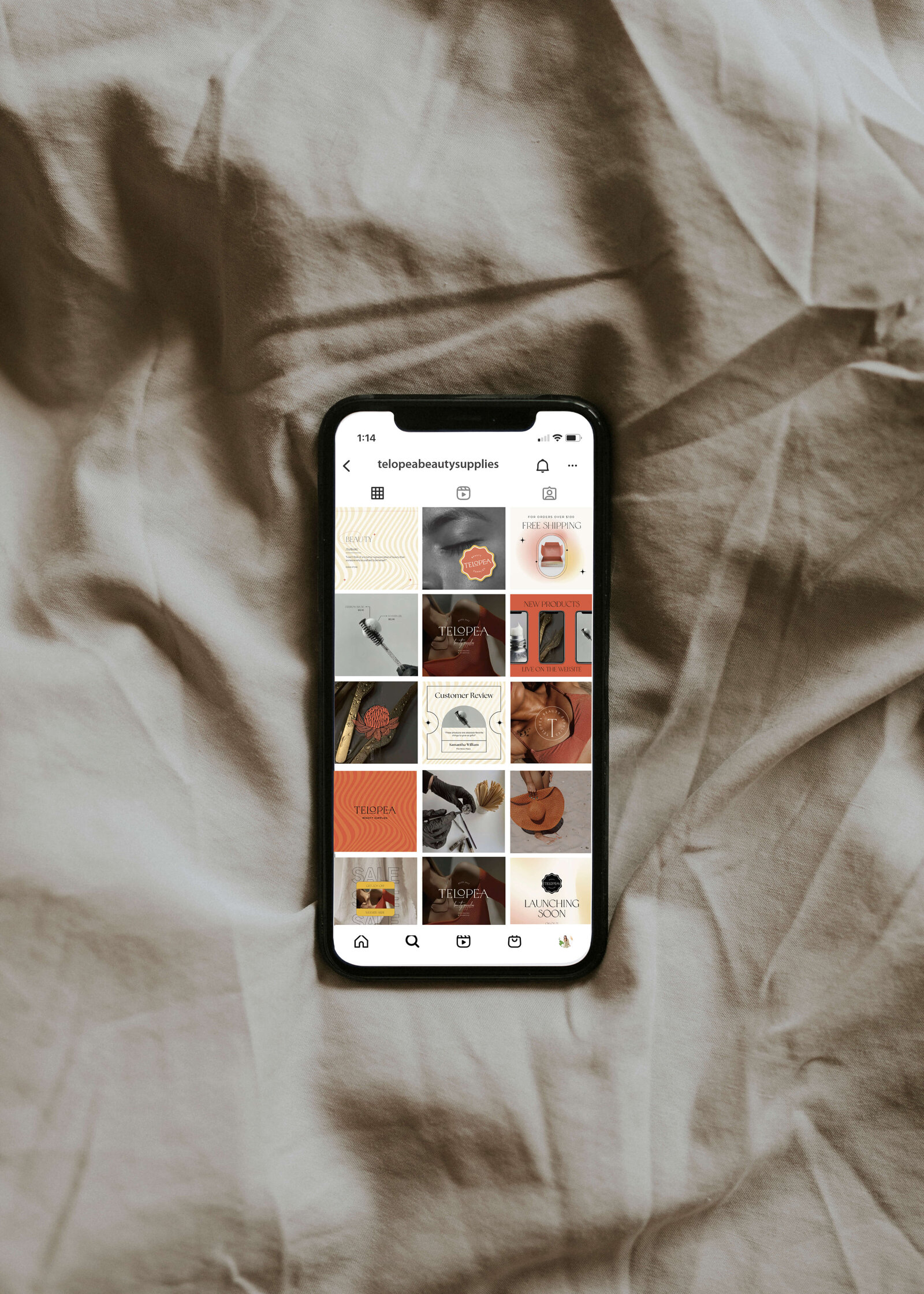 an iPhone on a tan sheet, displaying a faux social media feed