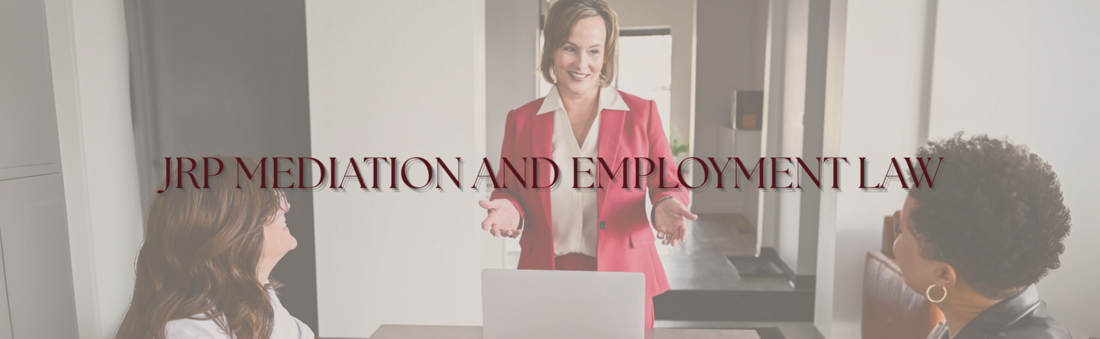 alt="Jennifer  R Petersen in a red blazer greeting clients in a professional office setting, JRP Mediation and Employment Law Firm"
