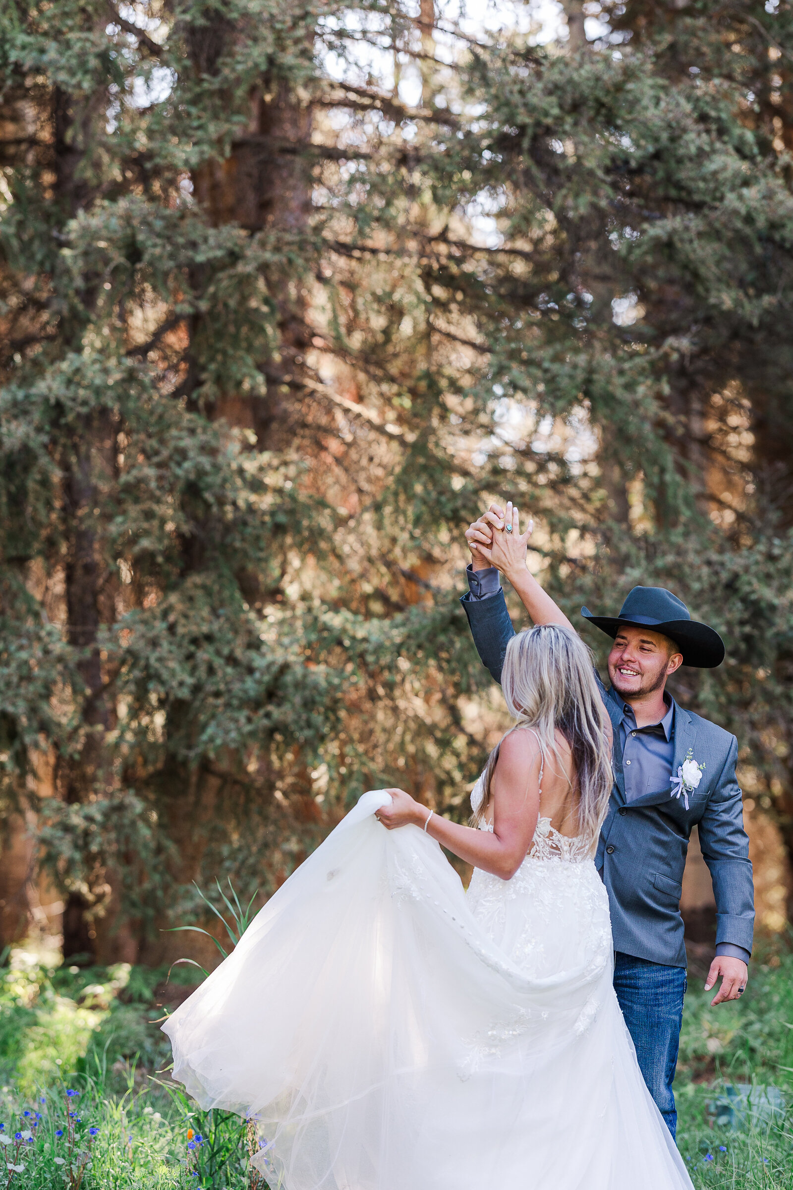 Groom spins bride during sunset photos on their wedding day in Arrowhead Colorado