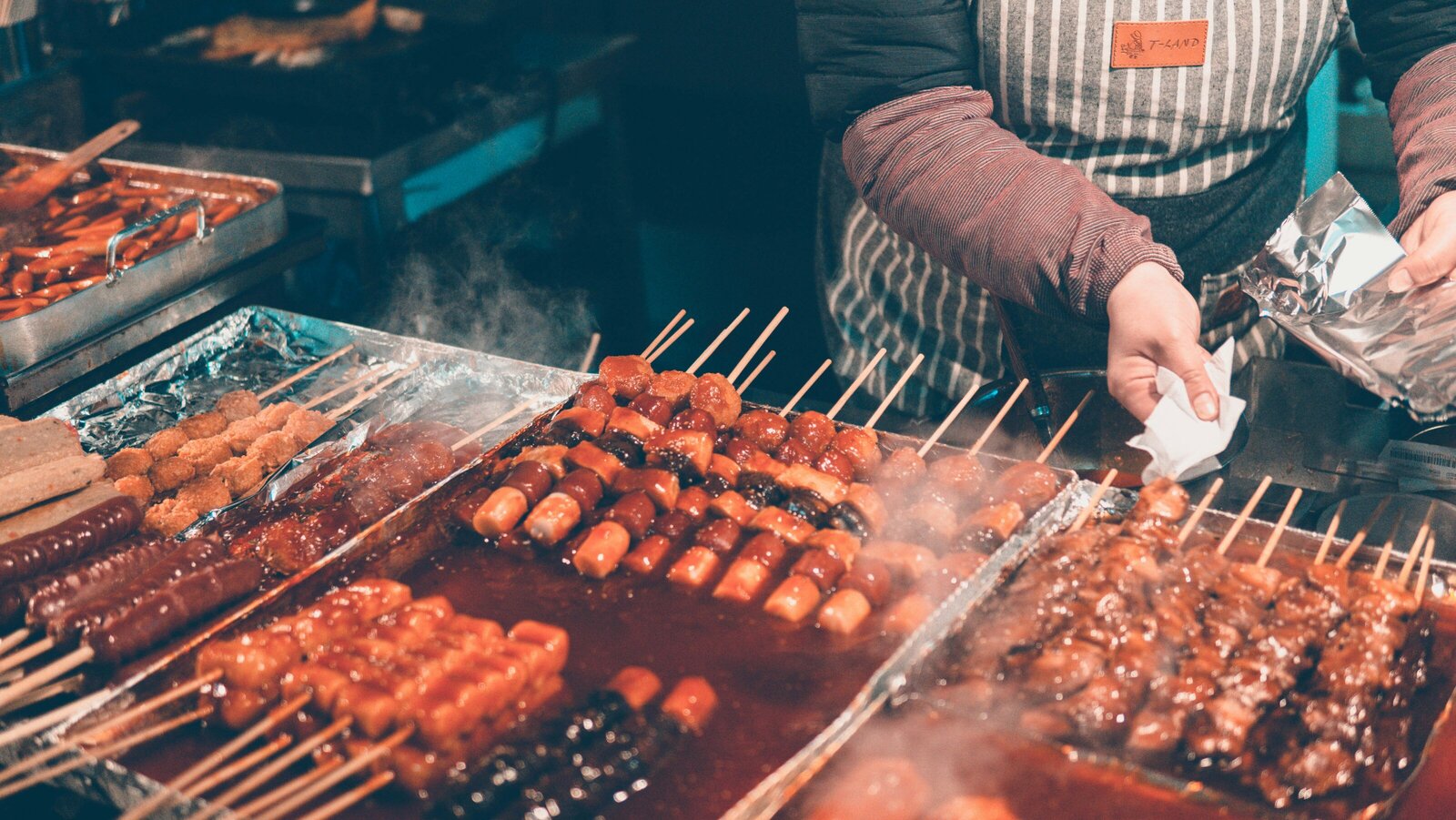 Myeong-dong, Seoul’s vibrant district, is a street food paradise with spicy tteokbokki, crispy hotteok, and more. Kelsey Parry Travel curates top food experiences.