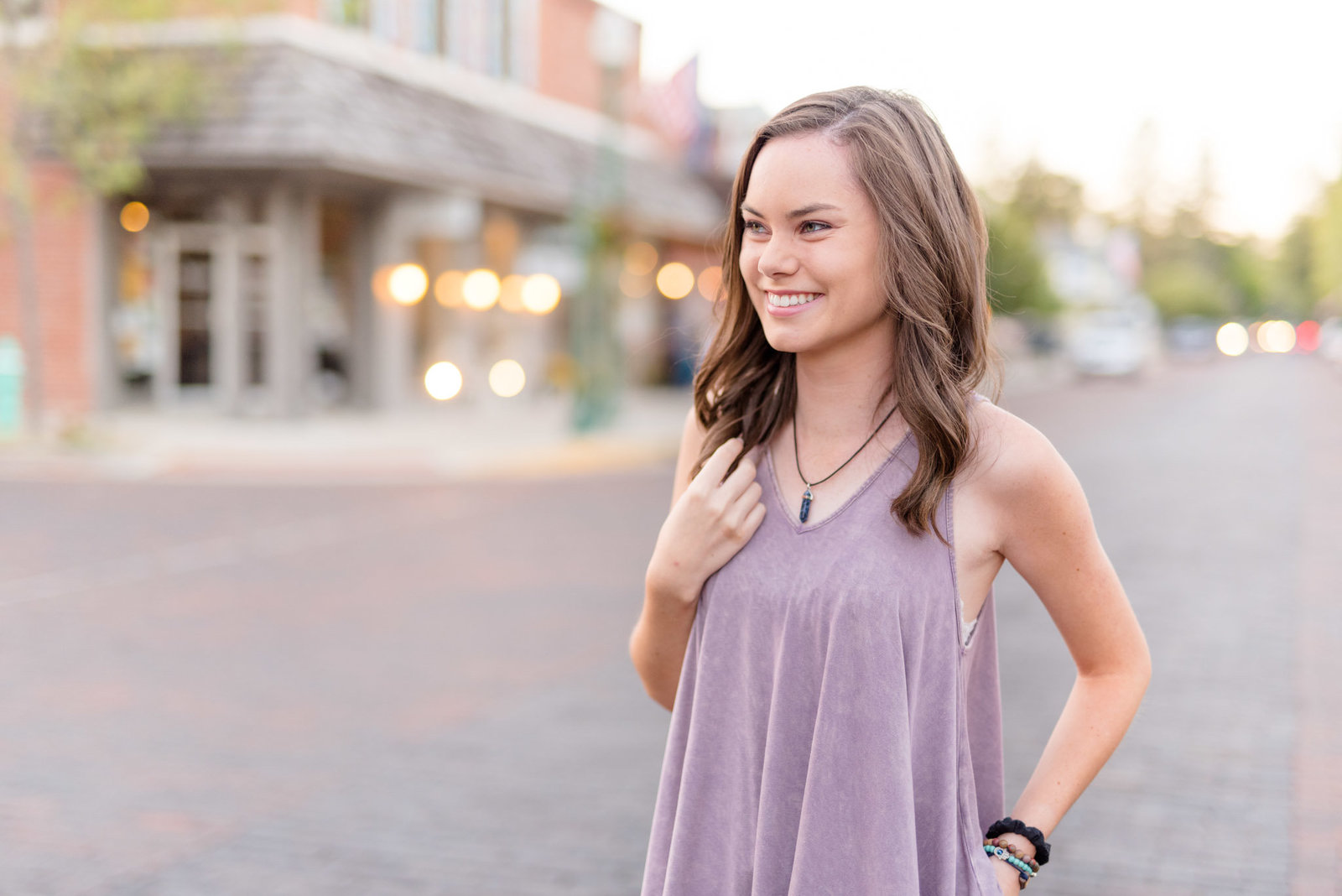 High school senior looks off camera and smiles.