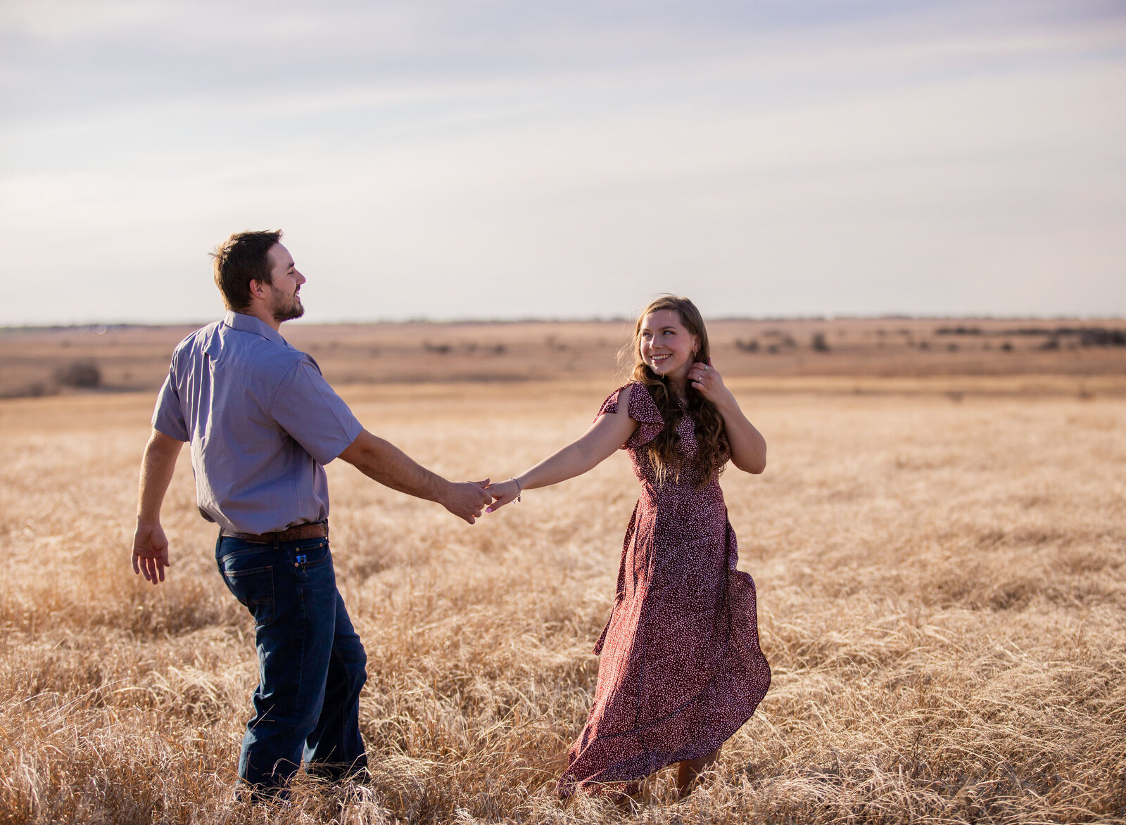 couple walking in wheat field