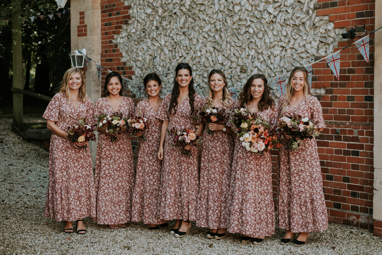 bridesmaids posing for a photo with bouquets