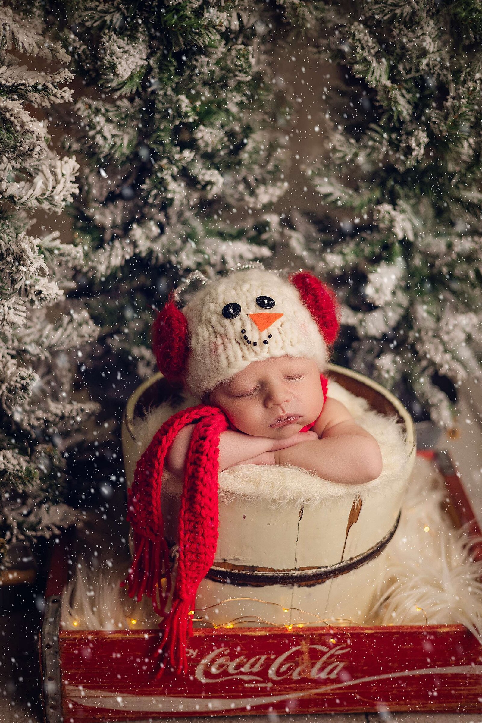 Newborn boy wearing a snowman hat, photographed by Bia Schaefer in a cozy in-home newborn session in Winter Park, Florida.