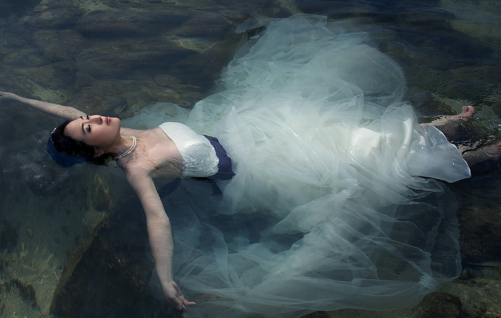 Chinese Bride floating on the ocean water with beautiful dress in Waikiki 