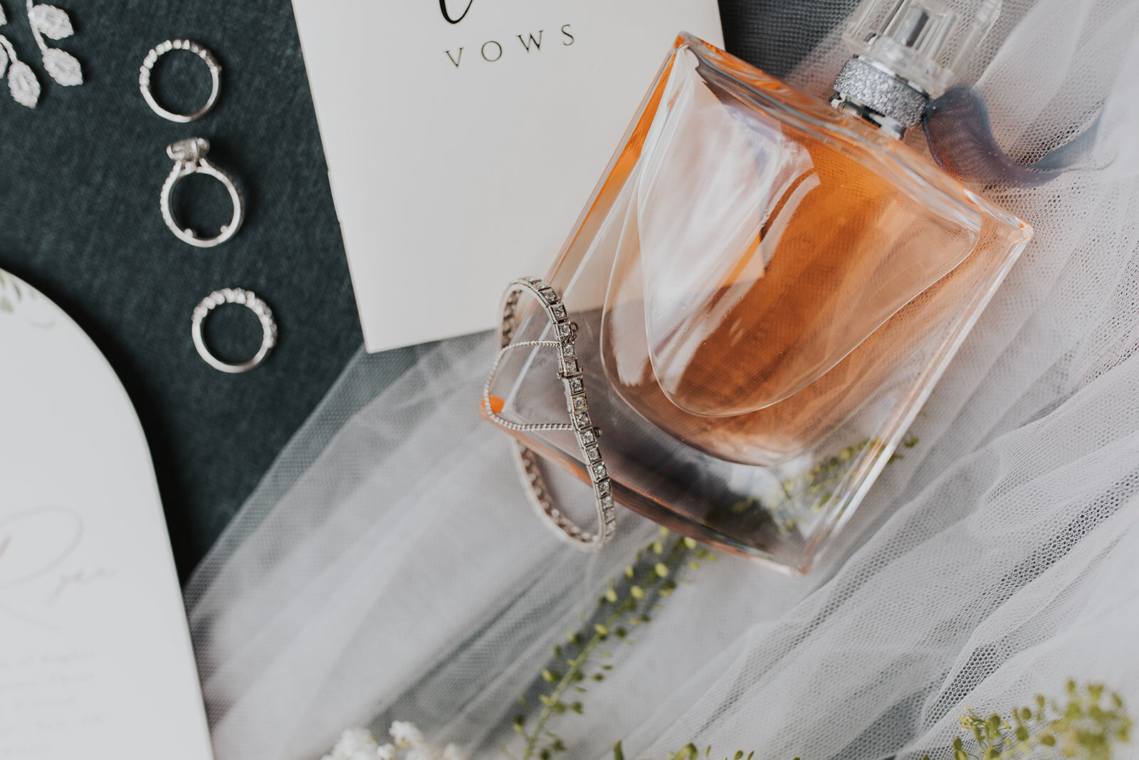 Wedding details- perfume, bracelet, and wedding bands