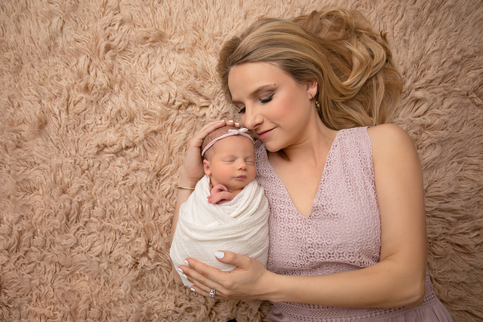 A stunning portrait of a mother cradling her newborn, radiating love and connection. This photo is part of our professional newborn photography services tailored for Phoenix families.