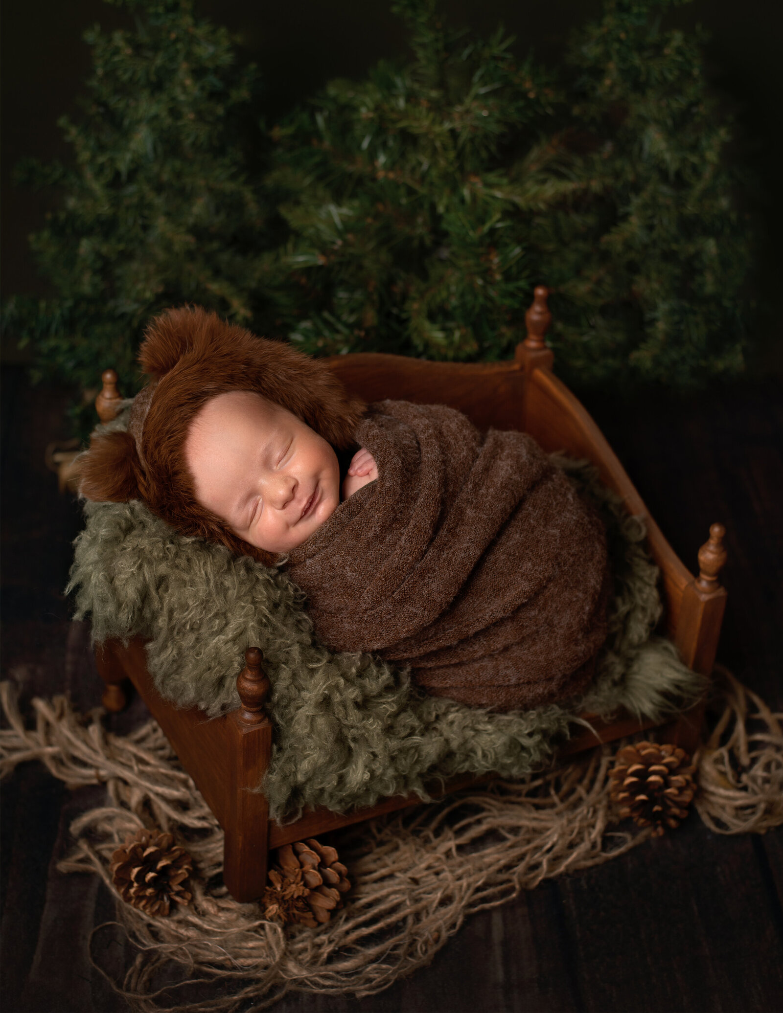 baby dressed like bear for newborn photoshoot outdoors woods