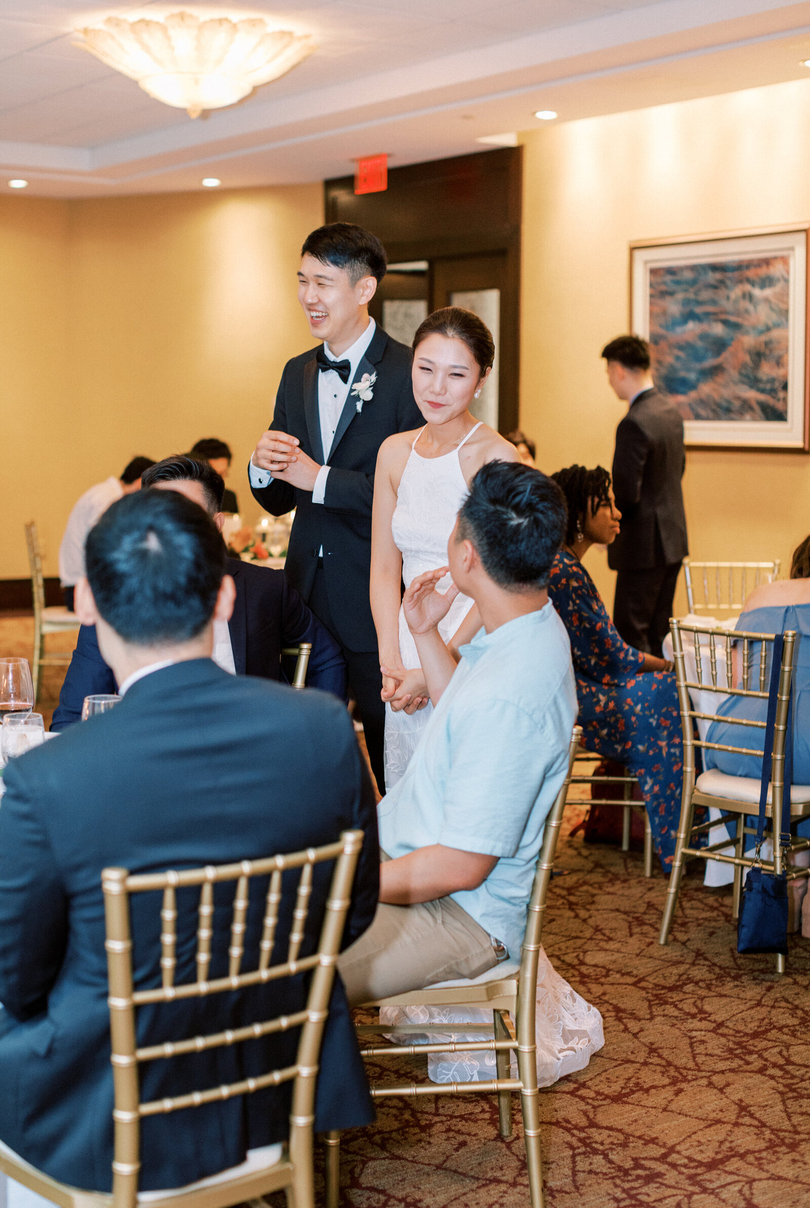 Bride and groom chat with wedding guests