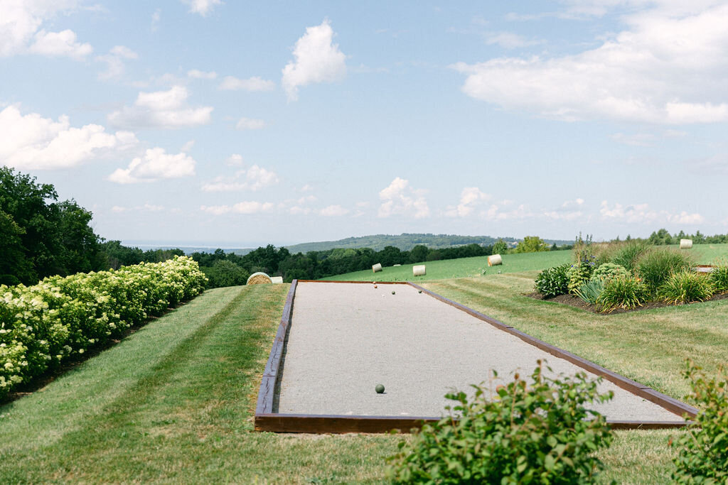 rolling hills frame bocci court with gardens surrounding in Cazenovia New York