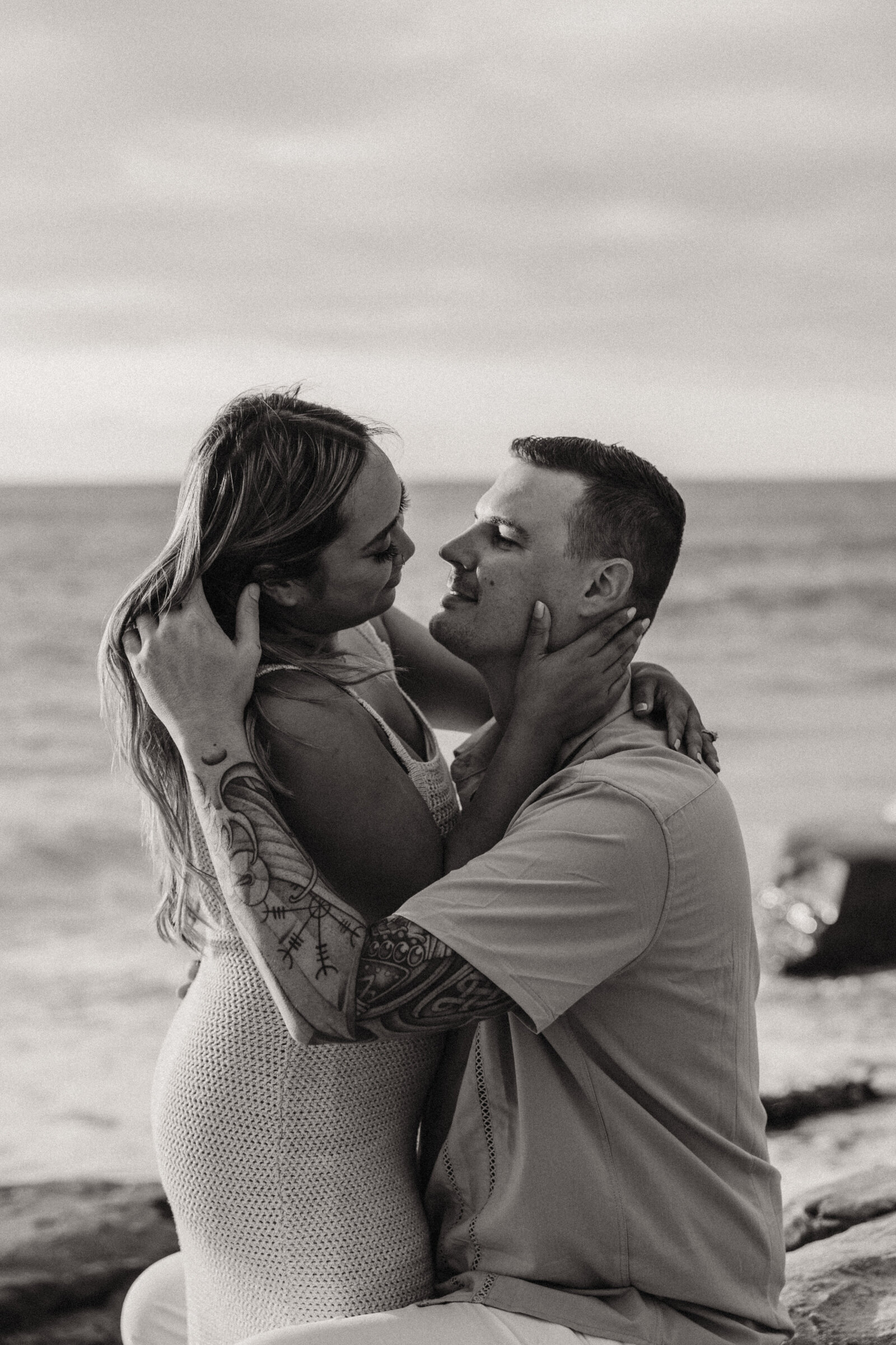 couple embracing at beach, mixed race couple, san diego beach session