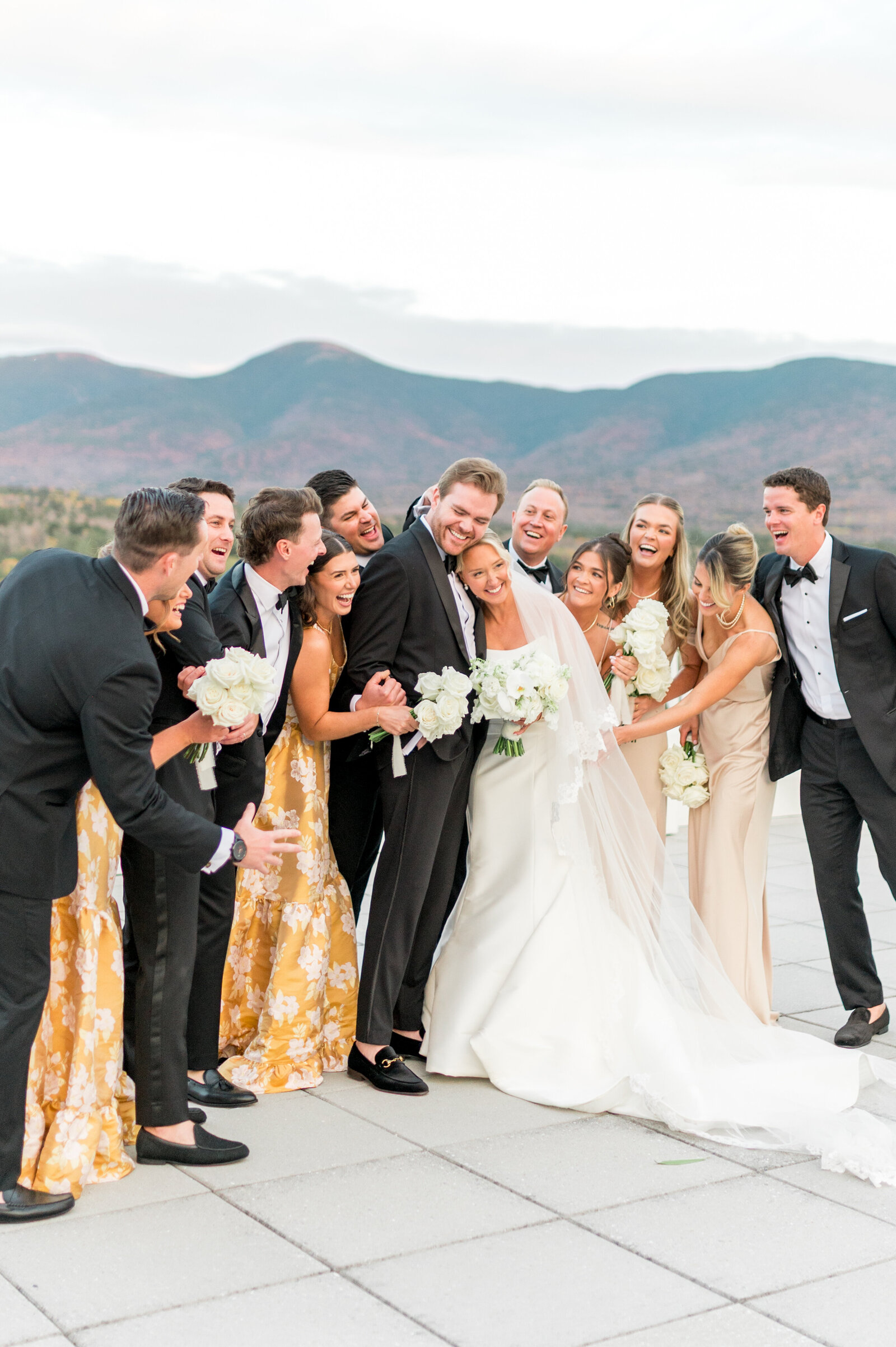 Bridal party celebrating with mountain views during luxury outdoor Omni Mt. Washington Hotel wedding — bright and airy photography by Sarah Surette Photography