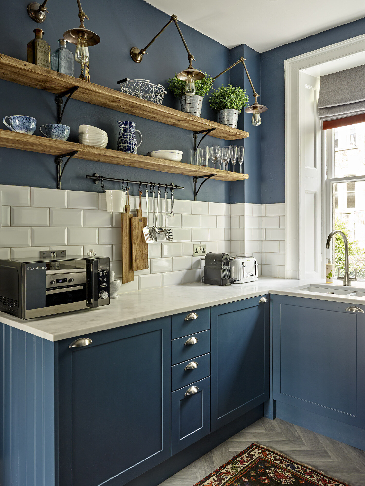 navy kitchen cabinets with wooden open shelving
