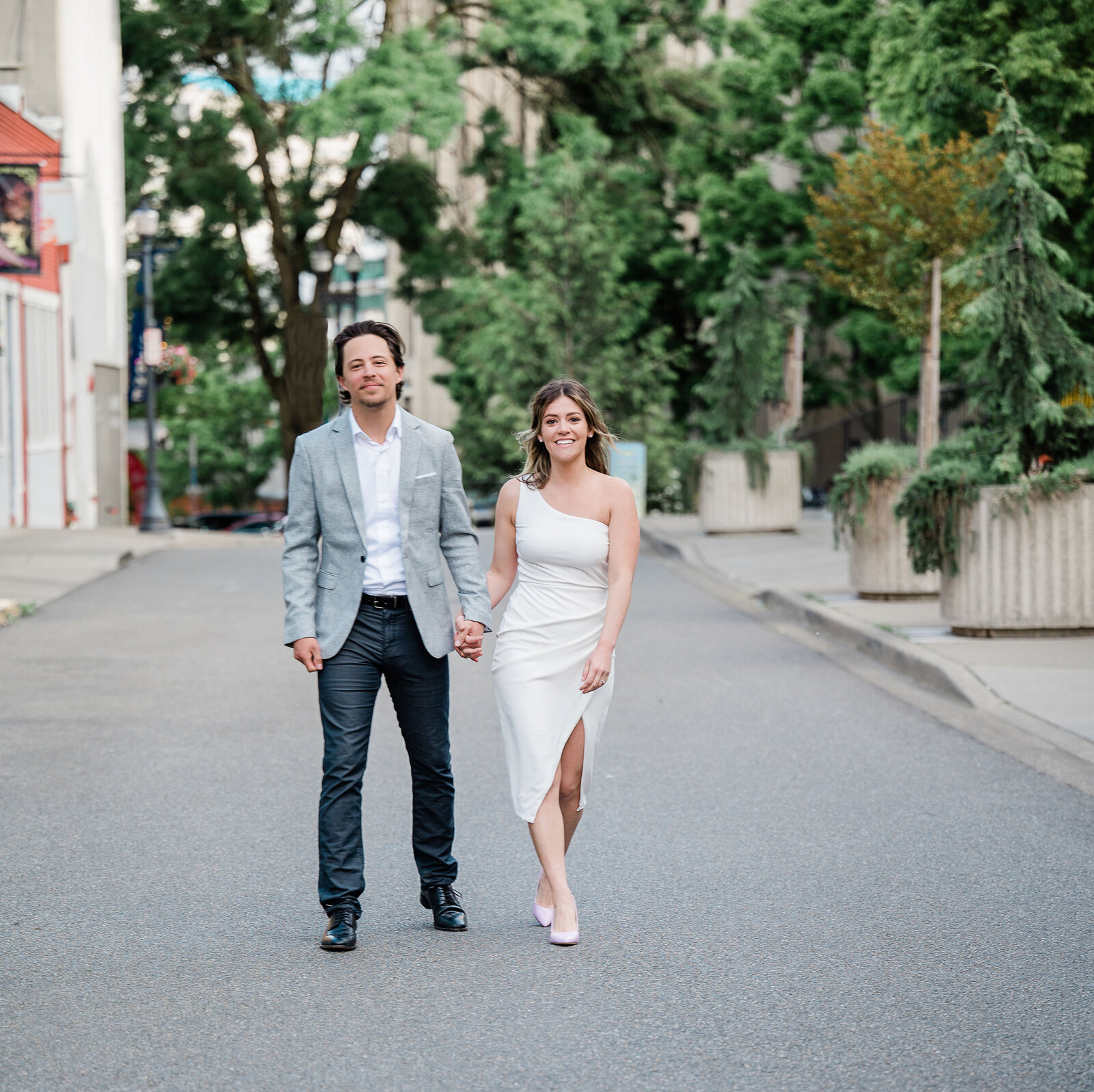 Couple holding hands and walking together in the street.