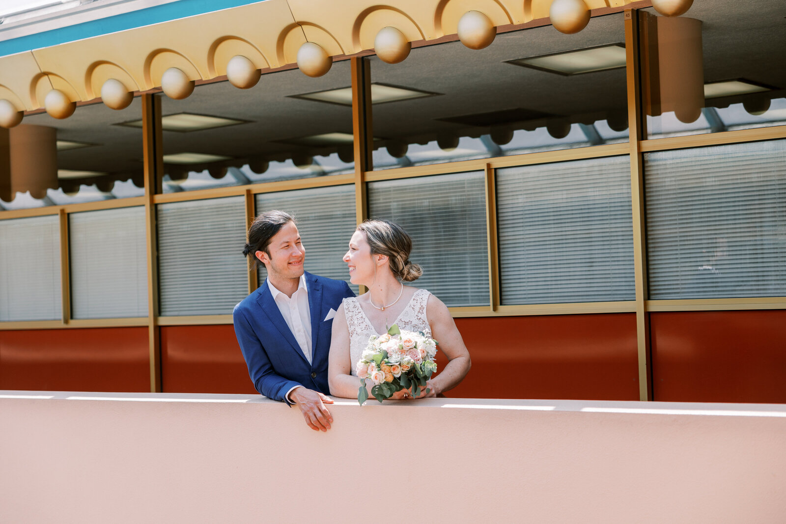 bay area photographers photographs bride in her bridal suite holdin gher gown as she is getting ready for her California wedding day