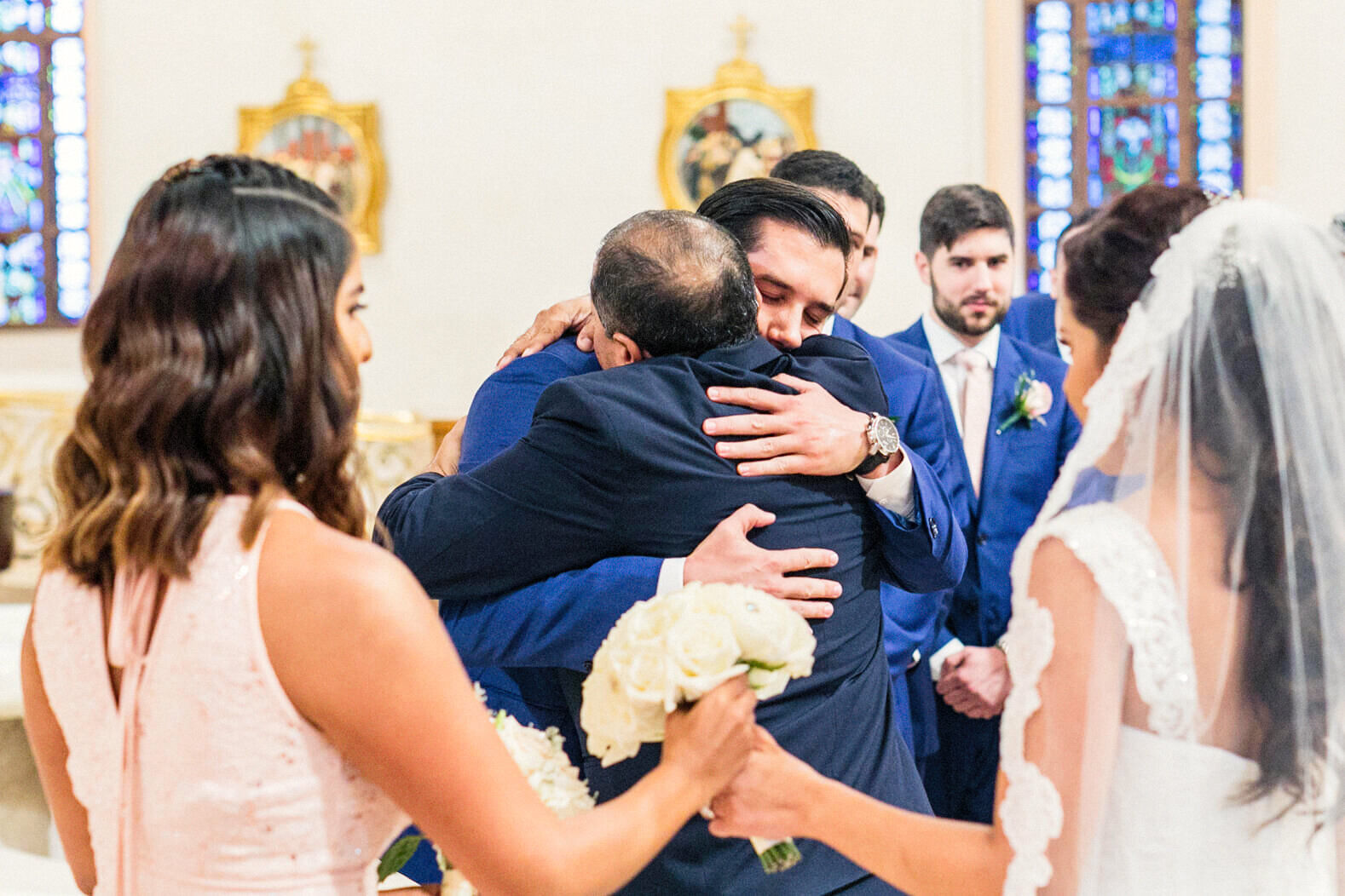 groom-hugs-father-in-law-catholic-wedding-ceremony-miami-beach-15