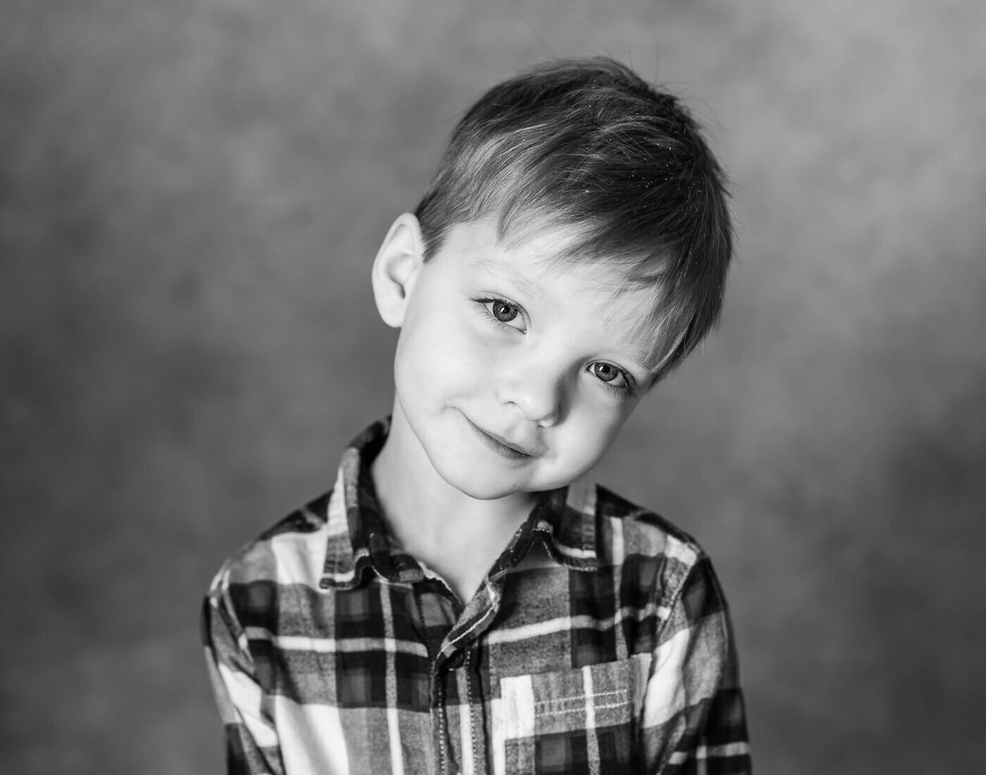A child has their head to the side, posing.