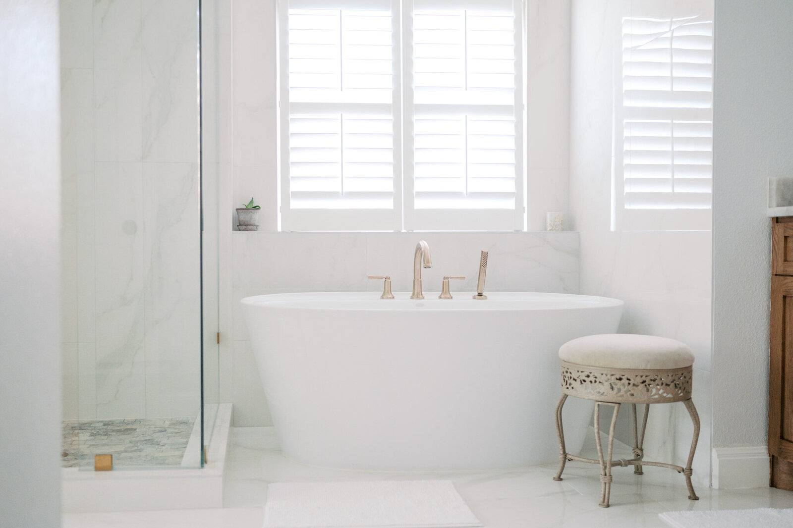 modern, freestanding white bathtub with gold fixtures