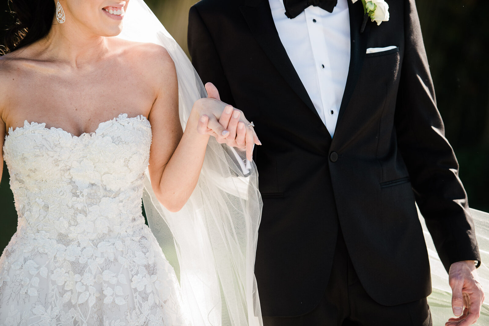 bride and groom holding hands