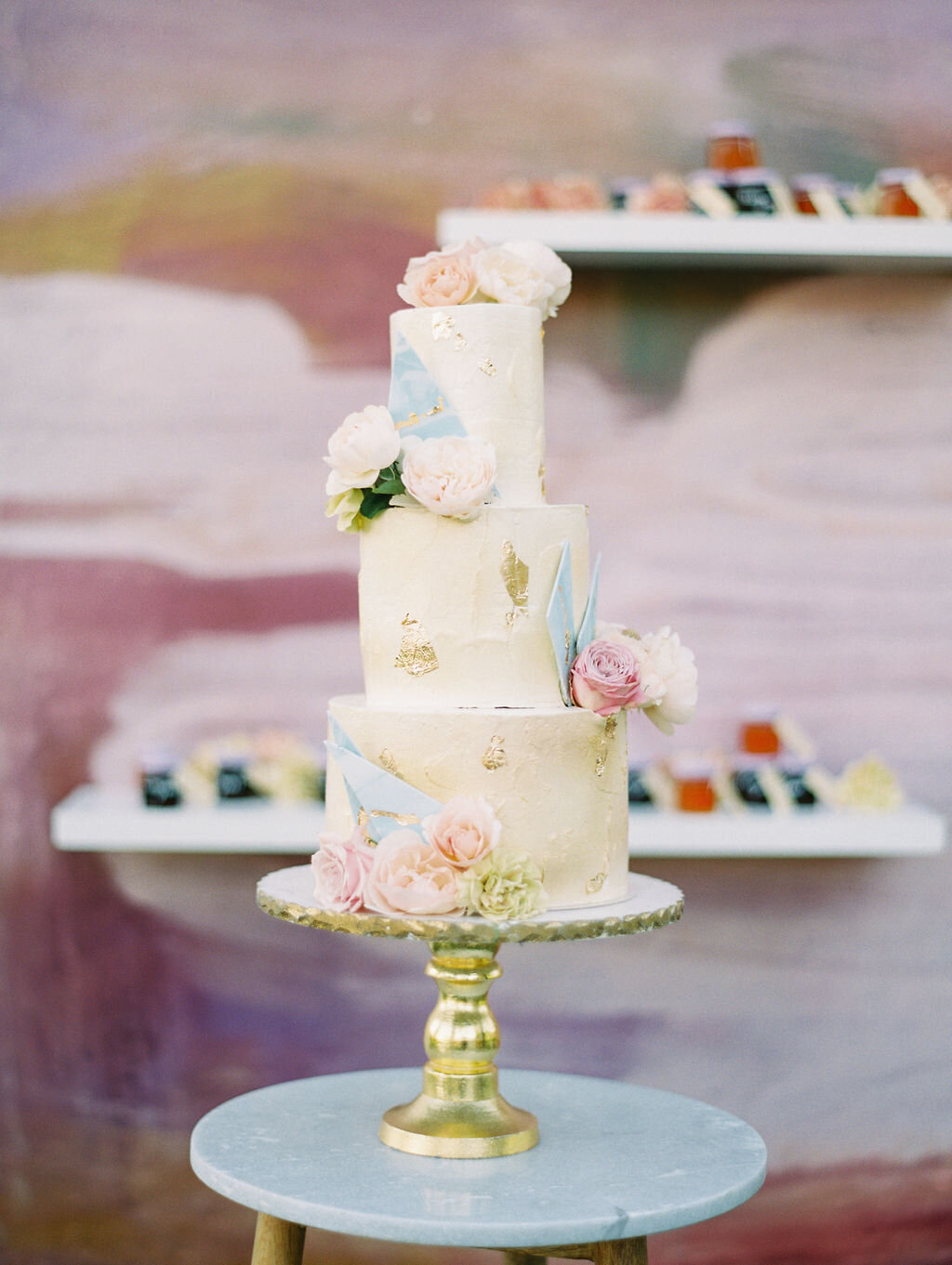 three tiered wedding cake with watercolor and lavender touches.