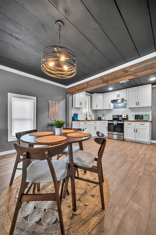 Dining area with view of the kitchen in this two-bedroom, one-bathroom vacation rental house for five located just 5 minutes from Magnolia, Baylor, and all things downtown Waco.