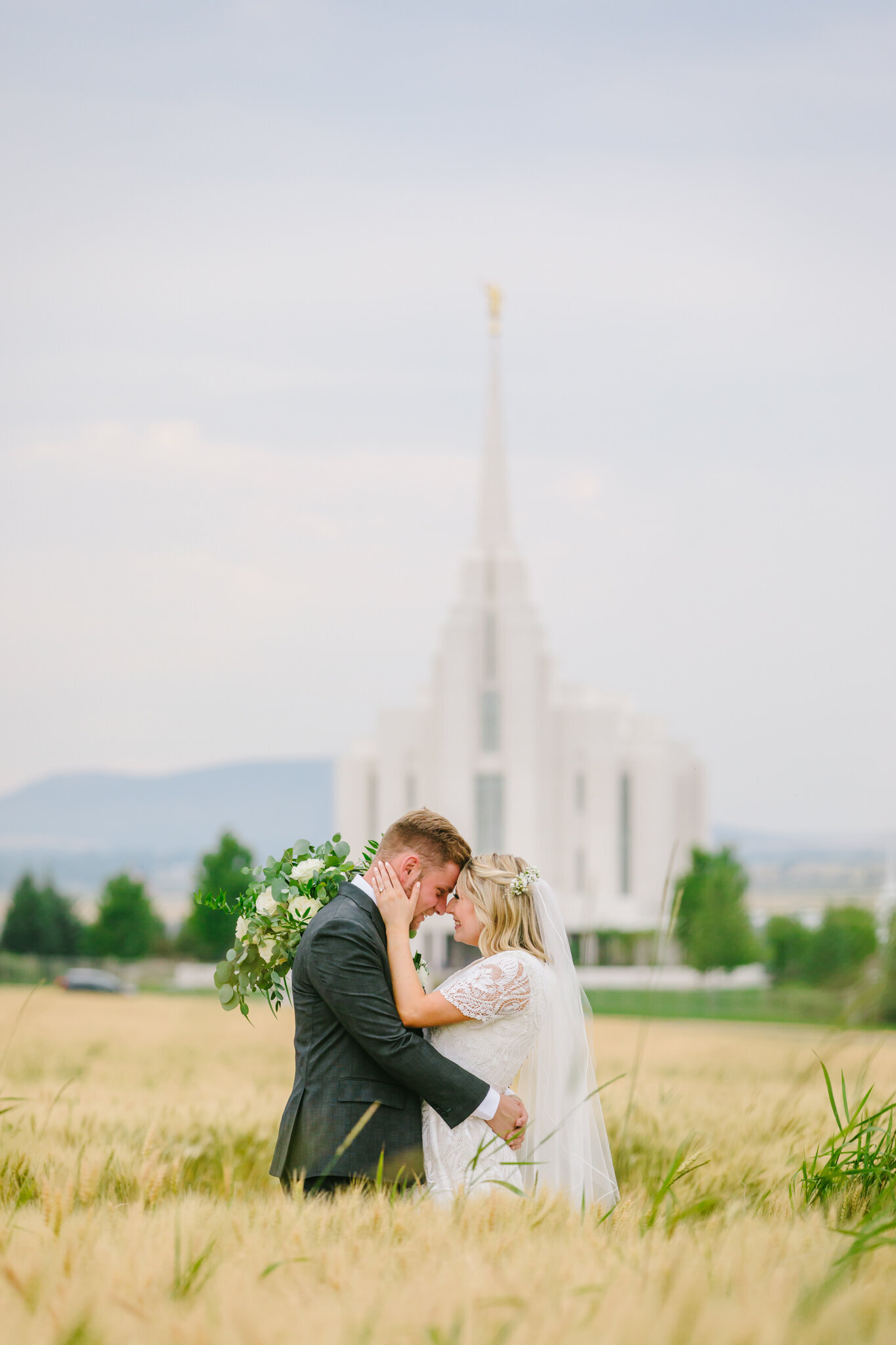 bride and groom in front of rexburg temple wedding