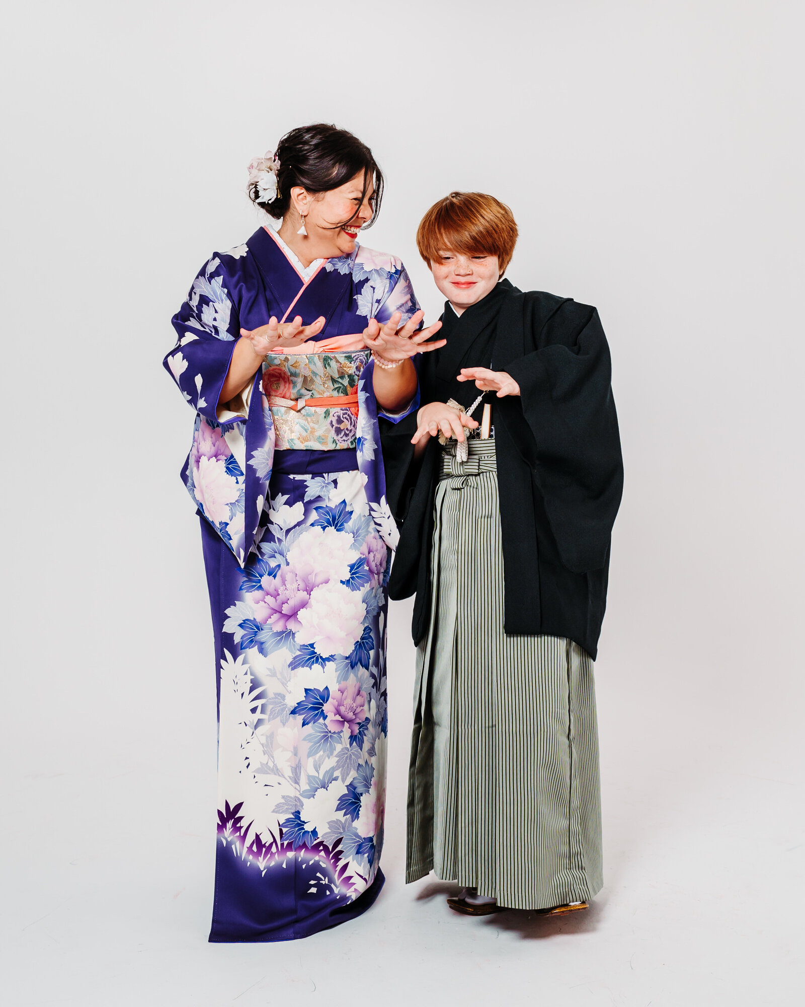 Mother and son sharing a playful moment in kimono and hakama during Shichigosan studio session | 七五三 母と息子 着物と袴 スタジオ撮影 ロサンゼルス