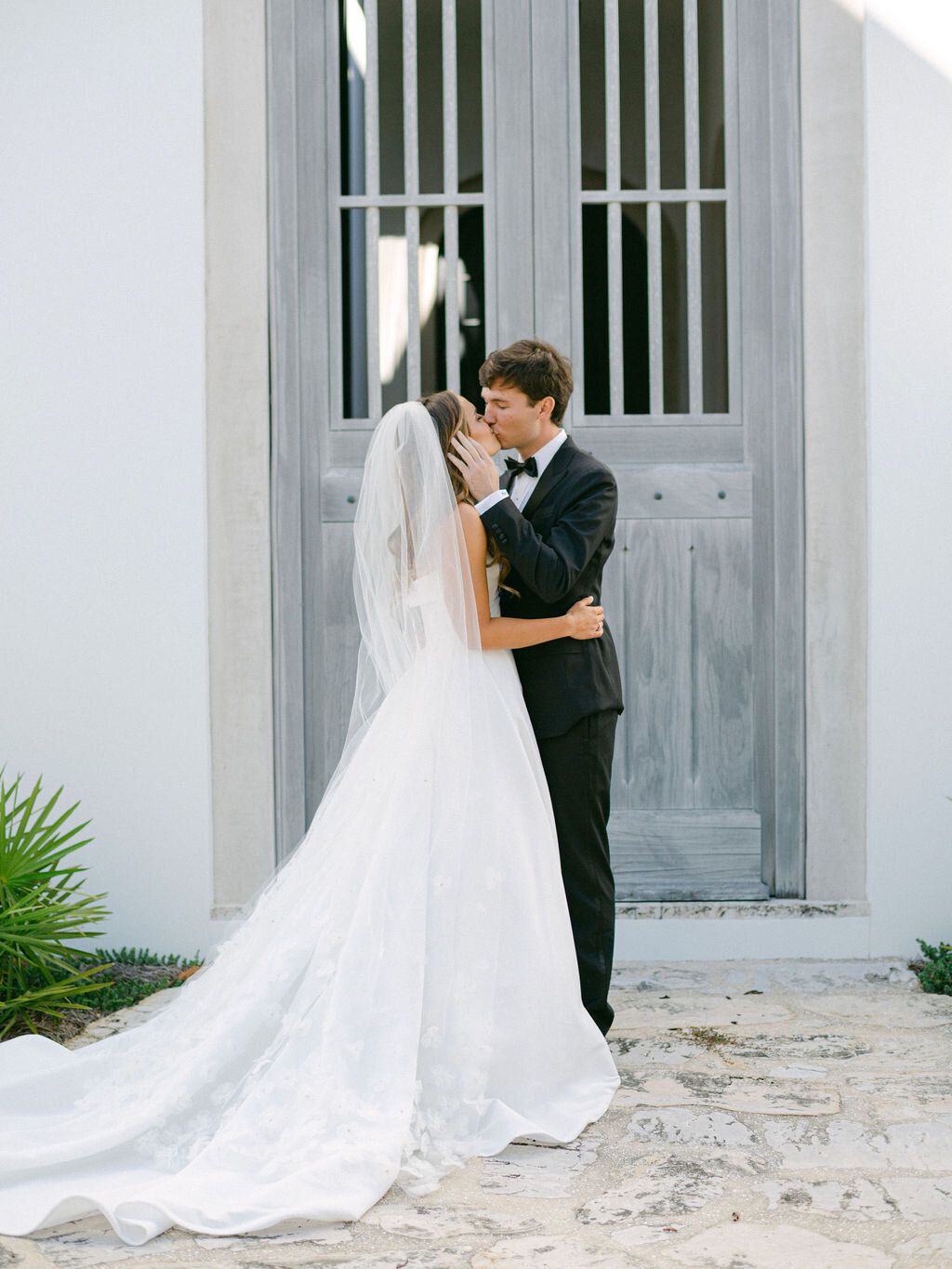Bride and groom kissing at Alys Beach