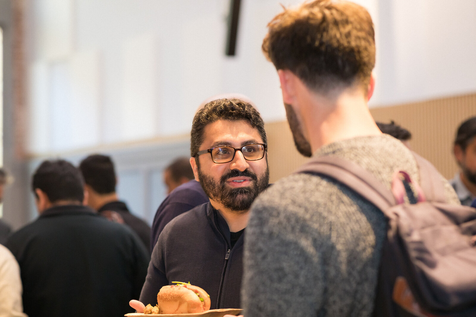 Small group conversations unfolding during the Holy Shift speaker event.