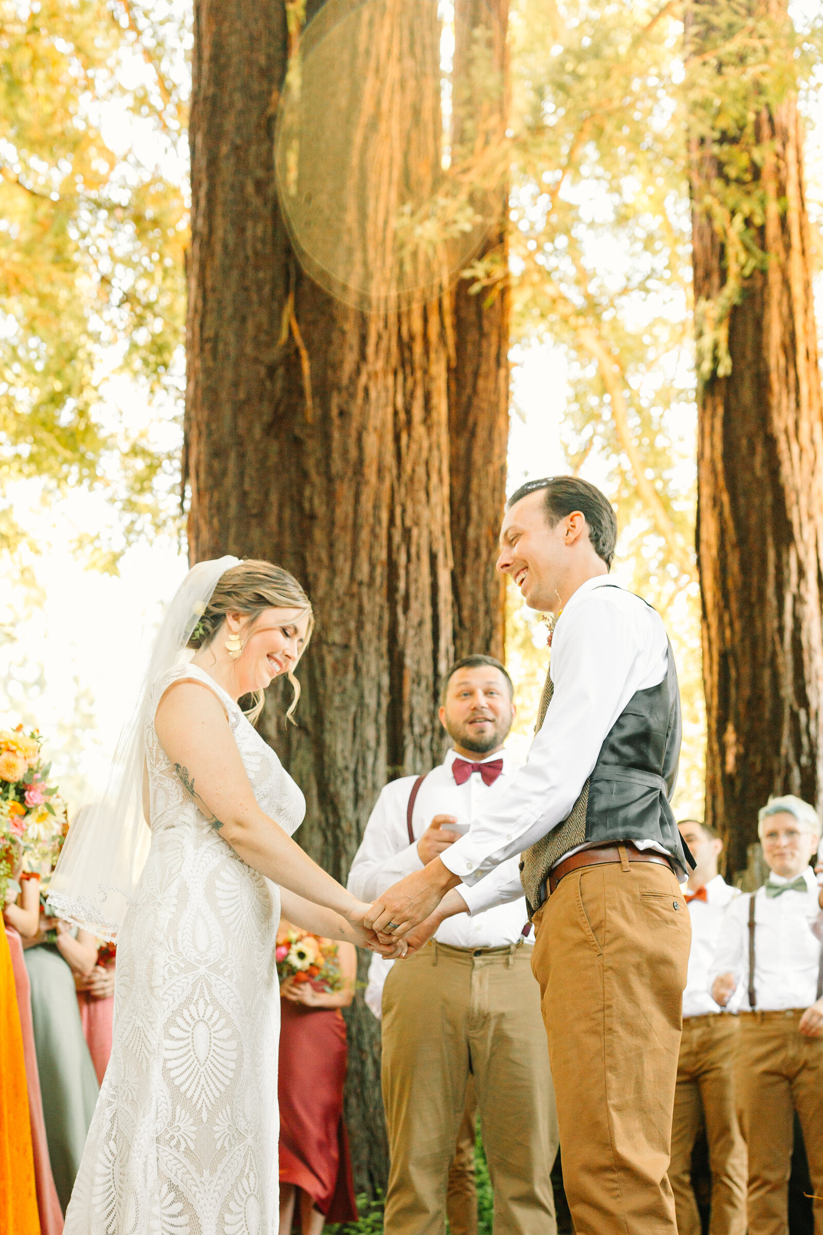 Bride and groom at their colorful wedding ceremony in Santa Cruz, California in the redwood trees.