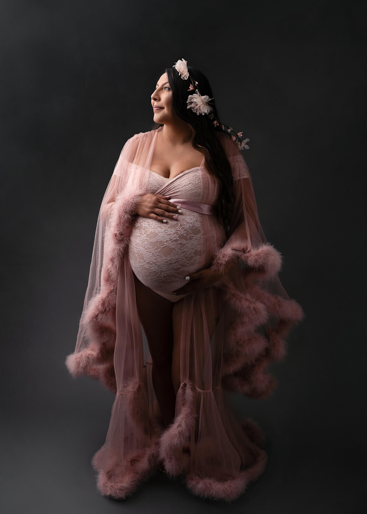 maternity picture of woman in a pink robe