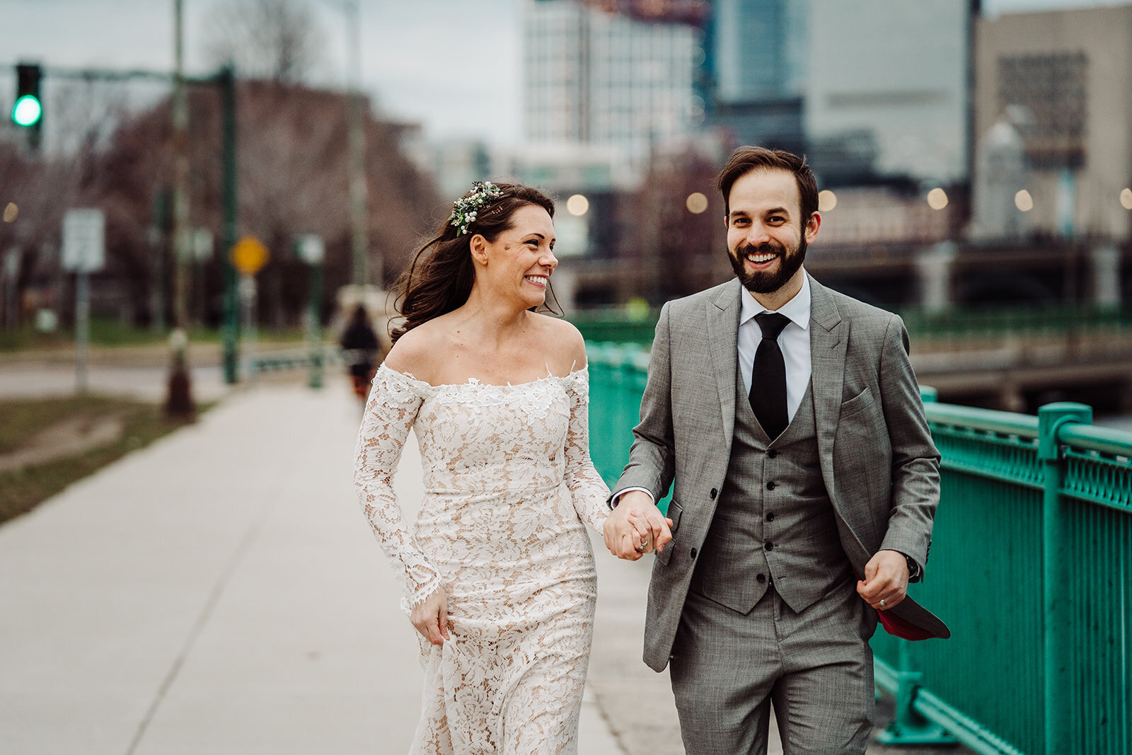 just married couple holds hands and runs in the city