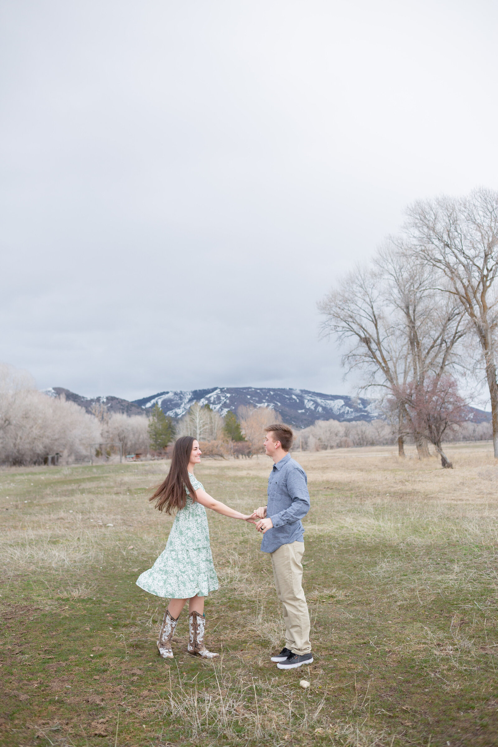 Seattle Wedding Photographer captures couple dancing in a meadow with mountains surrounding them