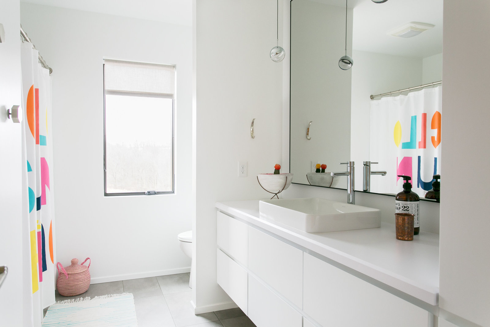 Minimalist and  gender neutral kids bathroom with fun pops of color