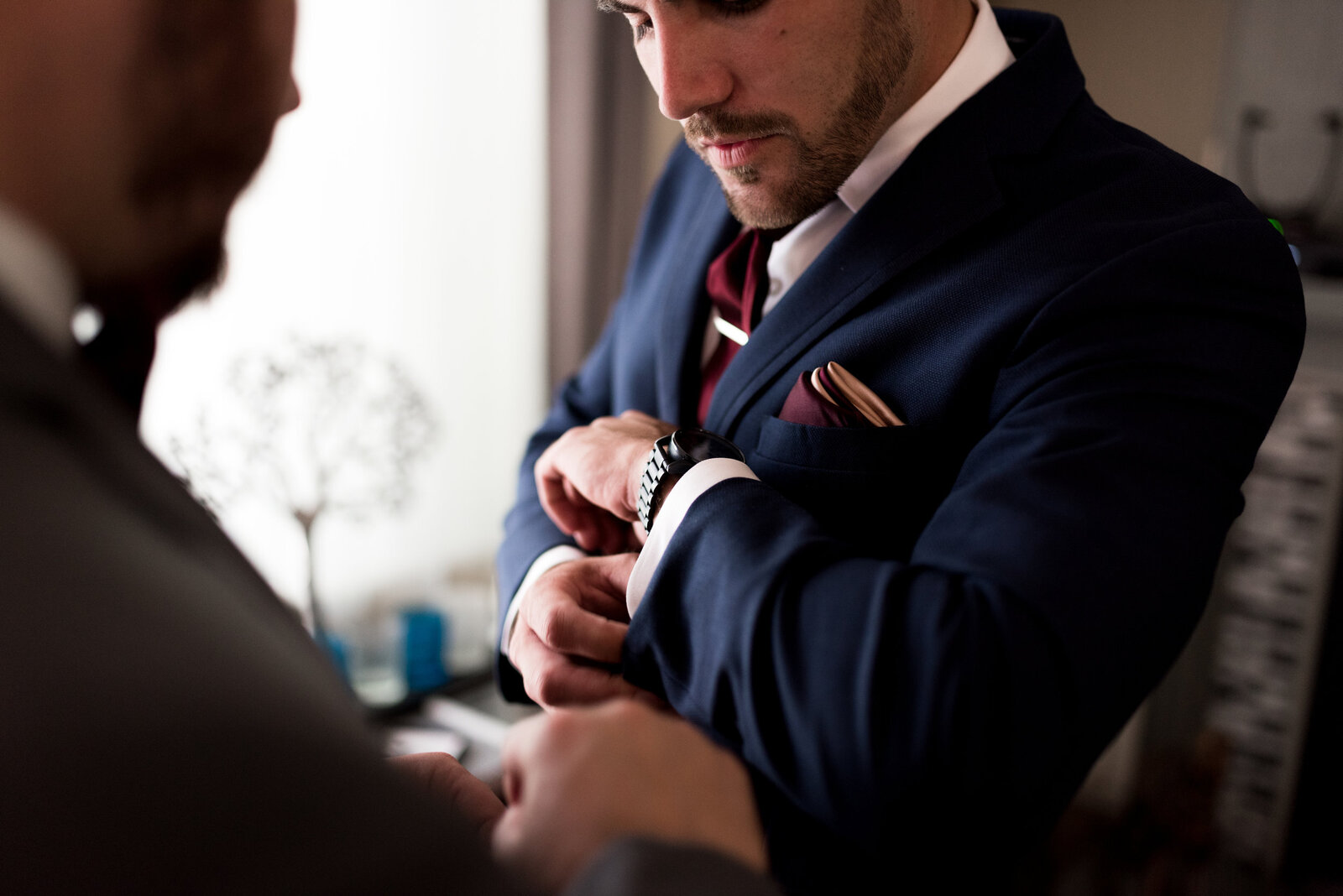 Groom putting on his watch and getting with his groomsmen for the wedding ceremony.