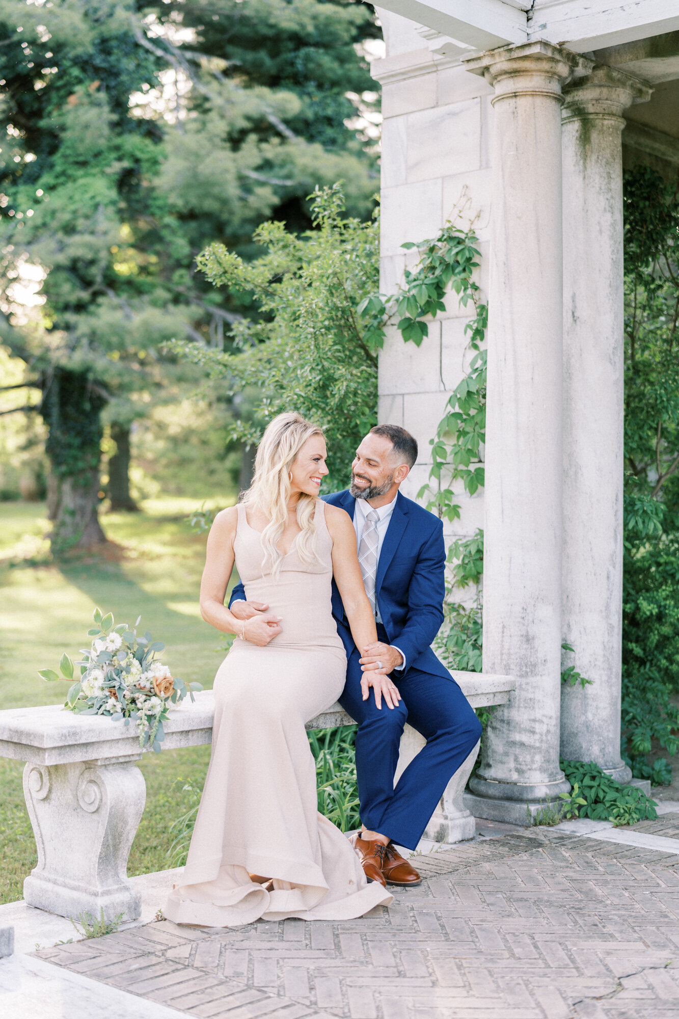 Newly weds sit on a bench at a stunning DC venue